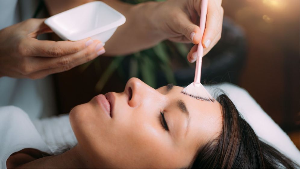 Person having a facial treatment brushed on