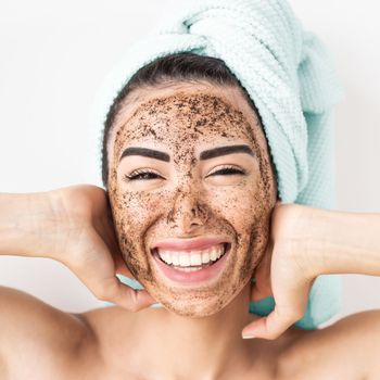 smiling woman cleaning her face