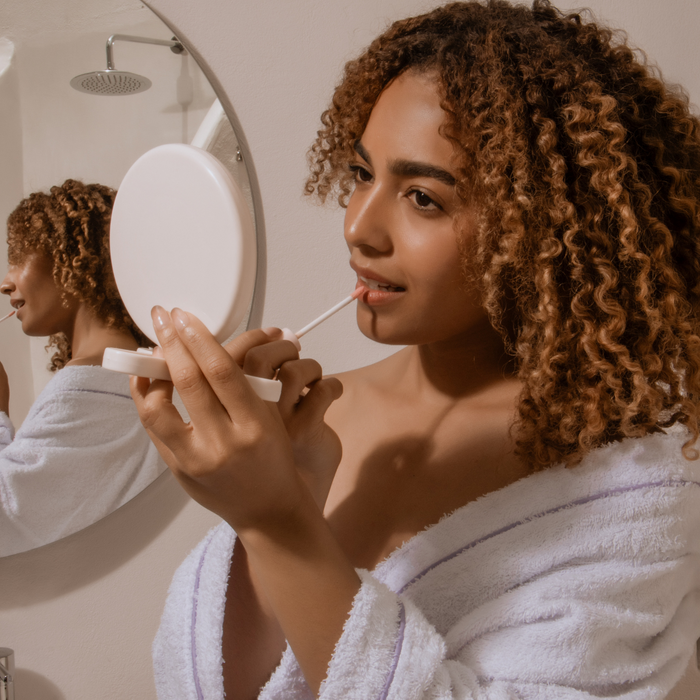 looking in mirror Back-to-School Beauty_ Lash Envy Facial Waxing Services 4.png