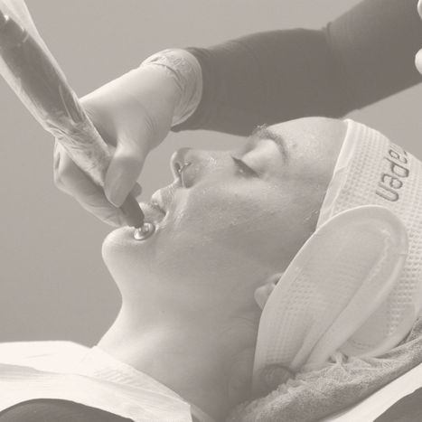 a woman getting a plasma pen treatment on her face