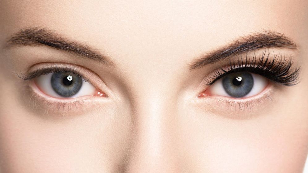 Woman with one lash extension and natural lashes on the other eye