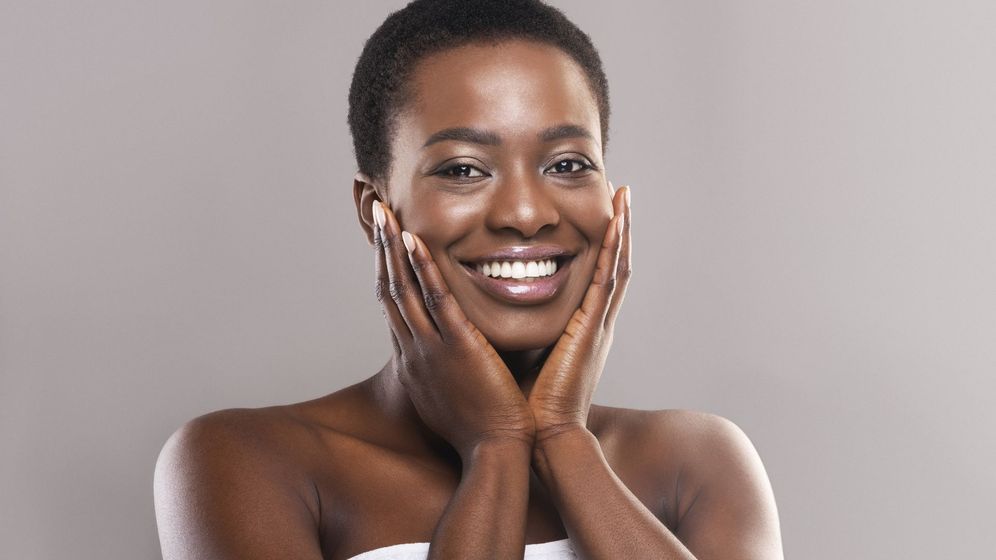 Confident woman with radiant, clear, and glowing skin
