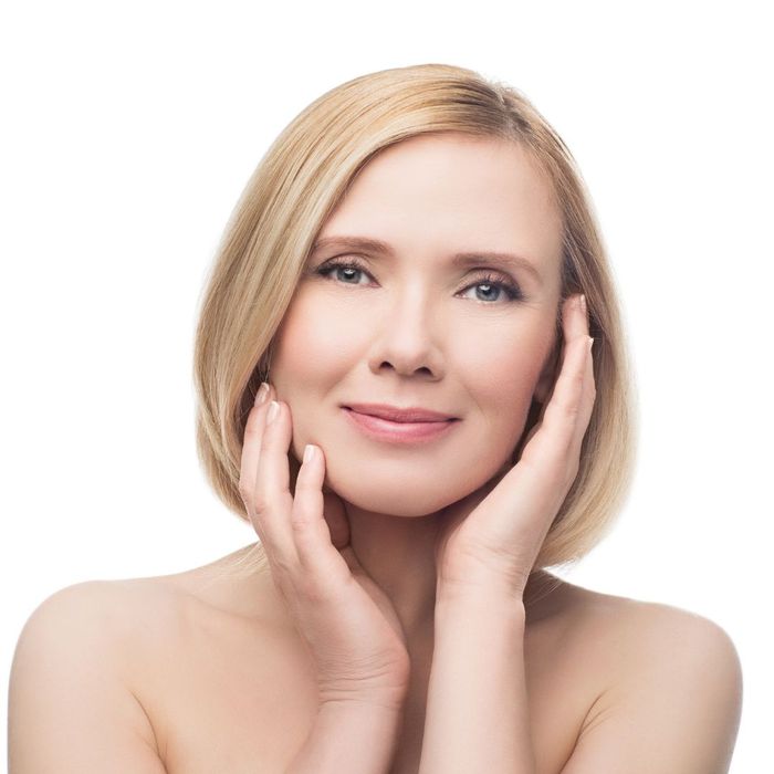 woman touching her face