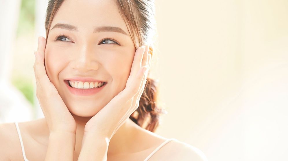 woman touching her smooth face woman touching her smooth face