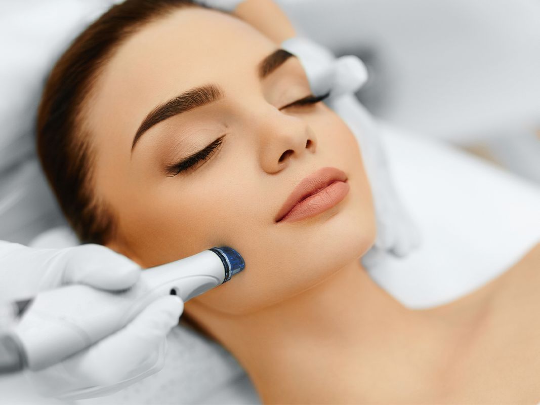 Photo of a woman receiving microneedling treatment