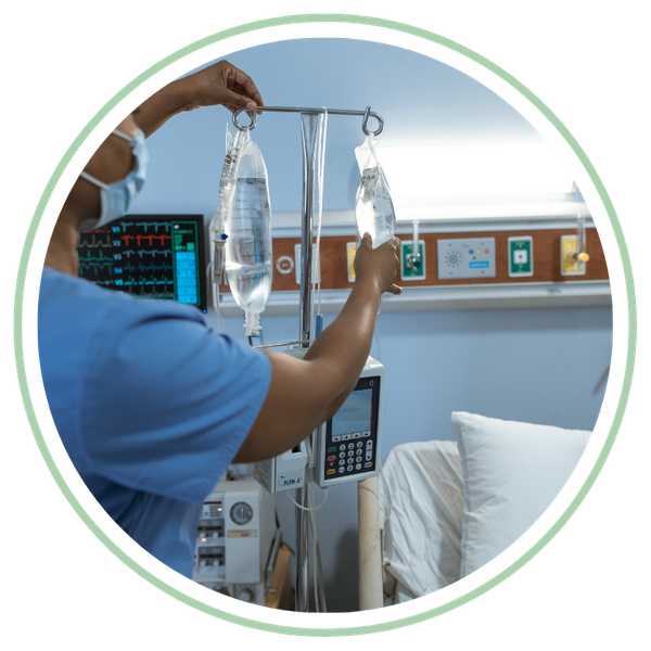 nurse adjusting saline bag in hospital room