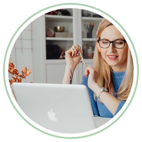 woman smiling looking at laptop filling out an online application