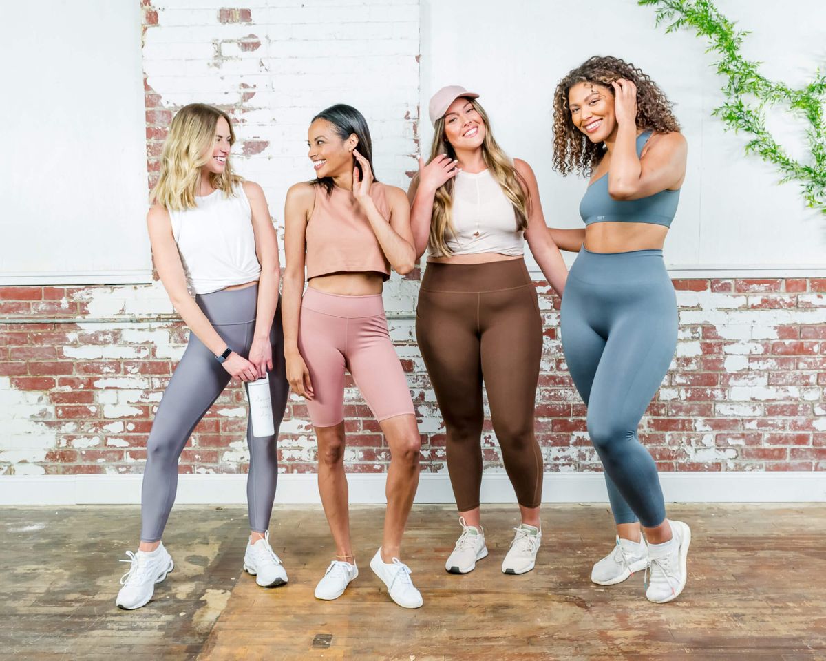 Group of people wearing workout attire smiling together