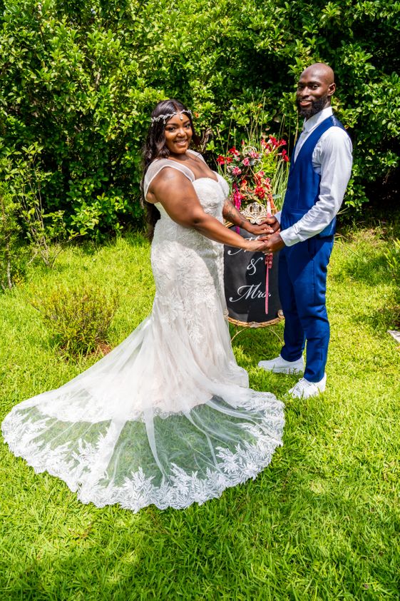 Garden couple with sign.jpg