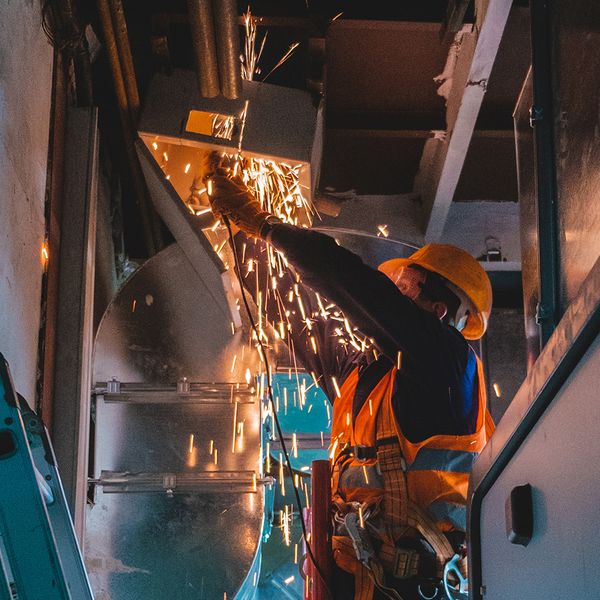 Professional duct worker installing ductwork. Professional duct worker installing ductwork.