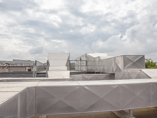 Ventilators on the roof of a tall building in an industrial area