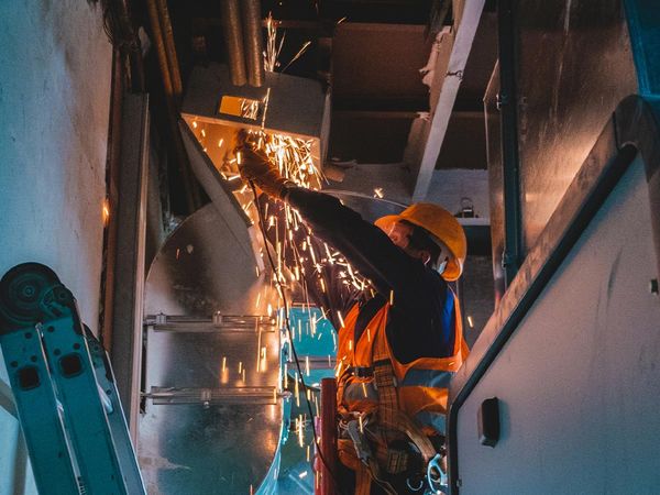 Image of a contractor repairing ductwork.