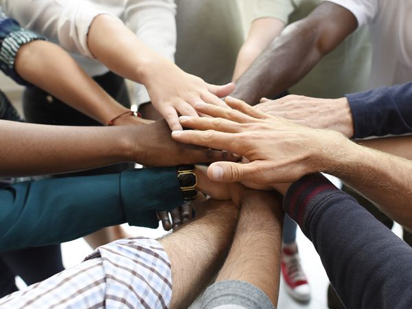  People putting their hands in a circle. 