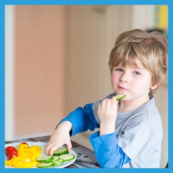 small child eating vegetables