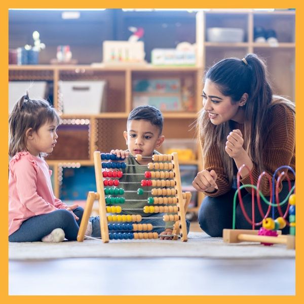 teacher playing with toddlers