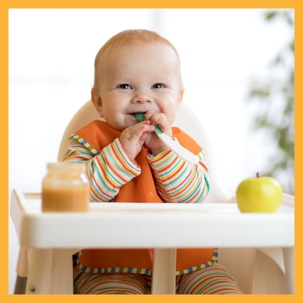 smiling infant in highchair