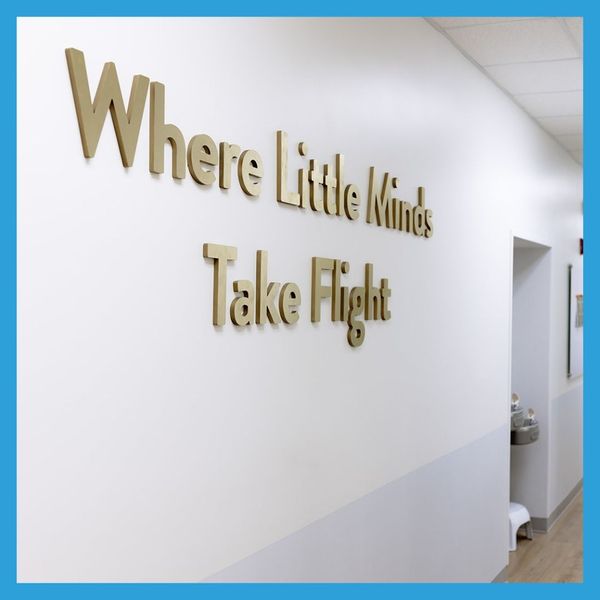 sign on wall that says where little minds take flight