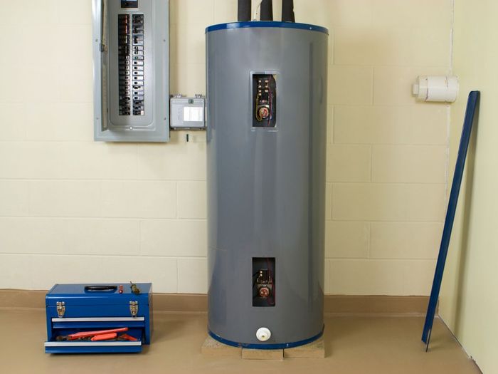 Image of a new water heater, post install with a toolbox to the side