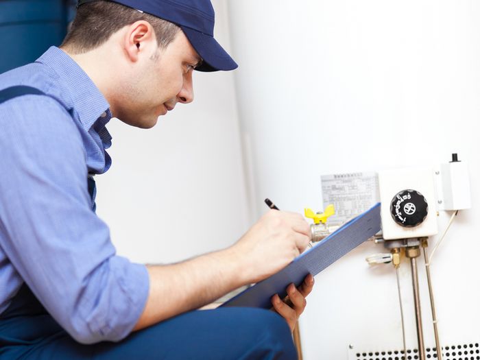 A technician replaces a hot water heater