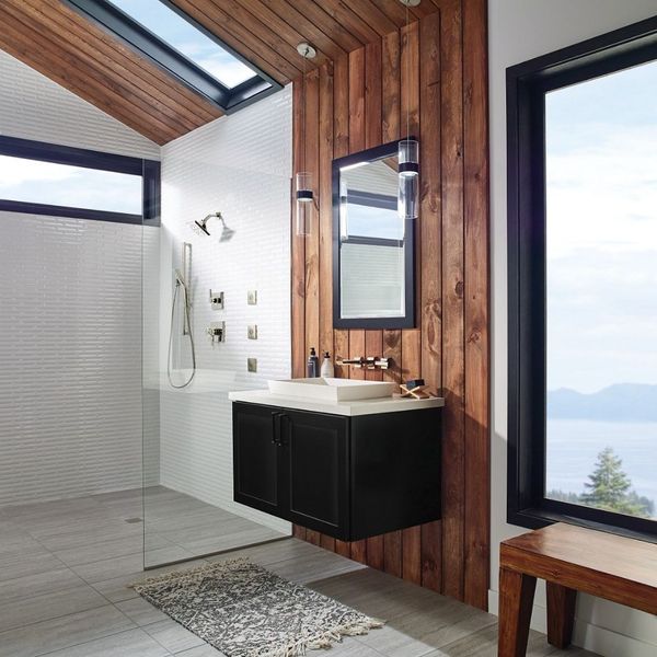A modern bathroom with a black floating vanity, a white vessel sink, a large window, and a wood accent wall next to a glass-enclosed shower. A modern bathroom with a black floating vanity, a white vessel sink, a large window, and a wood accent wall next to a glass-enclosed shower.