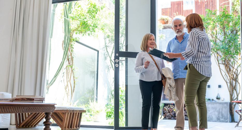 Real estate agent showing house to couple