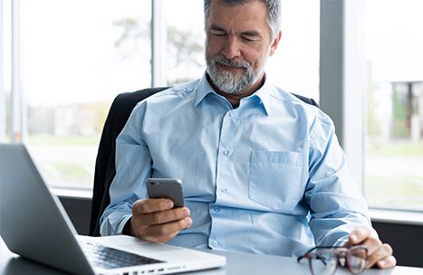 confident man looking at his phone