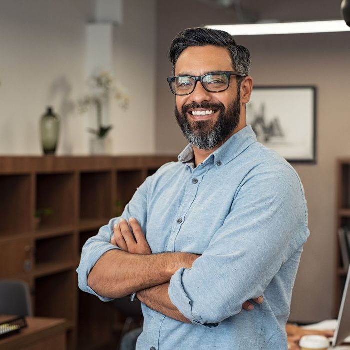 Person smiling with arms crossed