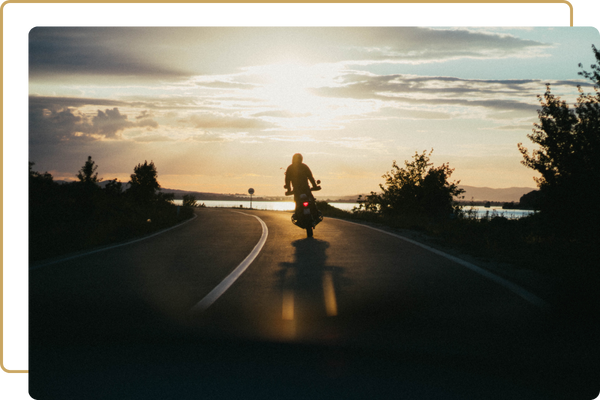 person riding a motorcycle down a winding road
