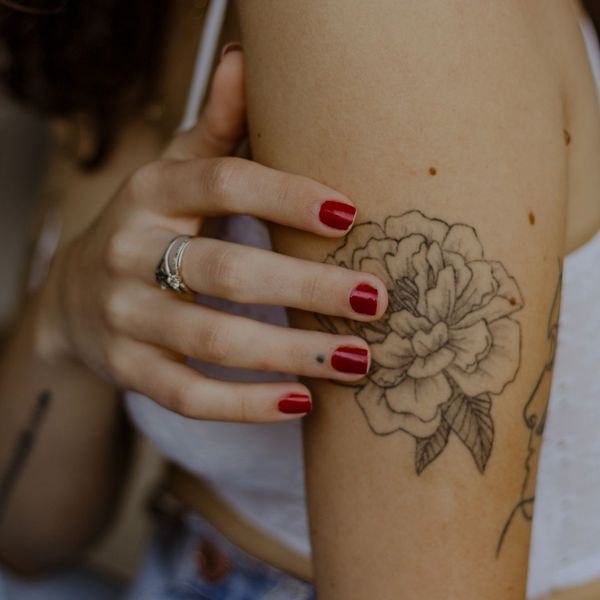 flower tattoo on woman's arm