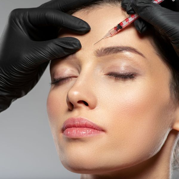 woman getting Botox injected into her forehead