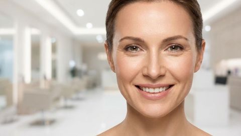 a smiling woman with natural-looking skin and expression lines in a modern salon setting a smiling woman with natural-looking skin and expression lines in a modern salon setting