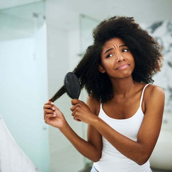 Black woman brushing hair