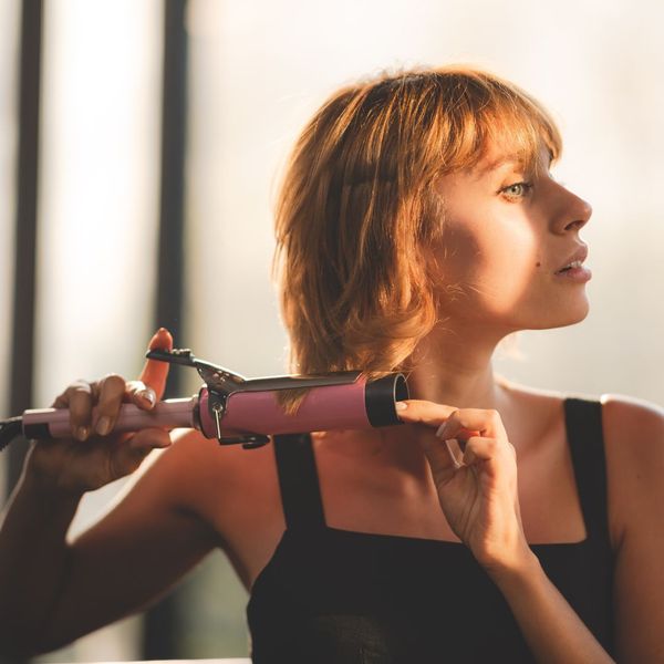 Woman curling hair