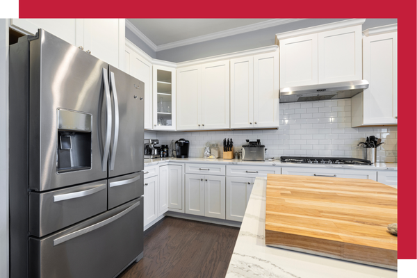 Modern kitchen appliances and stainless steel fridge