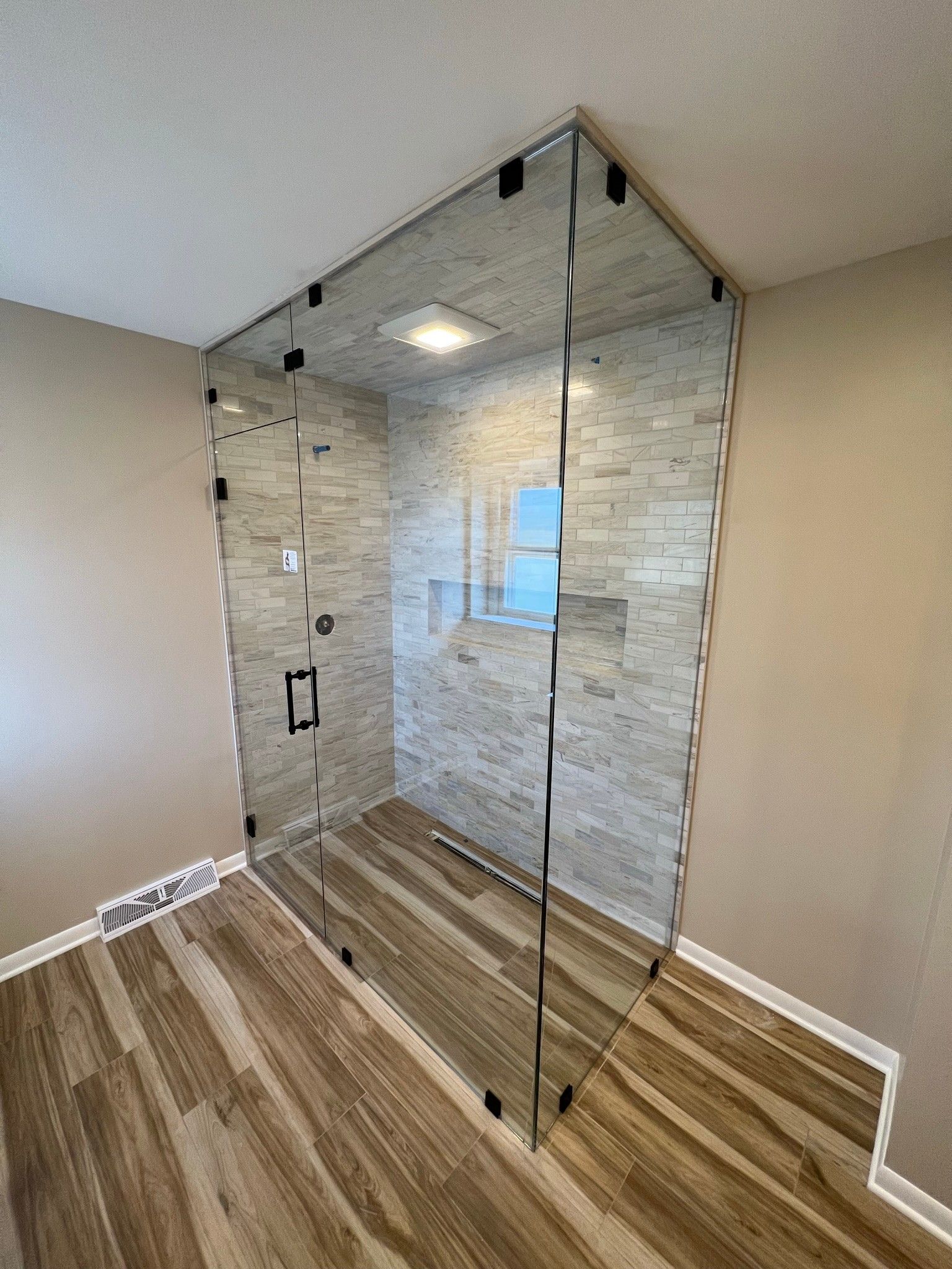 Close-Up of Frameless Shower Door with Chrome Hardware | Arlington Heights