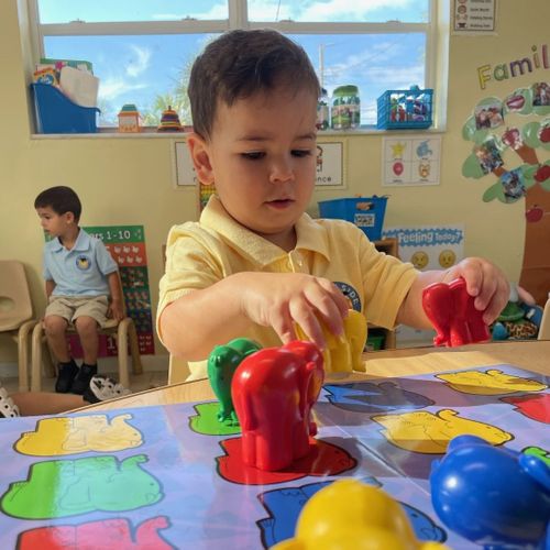 toddler using toys in classroom