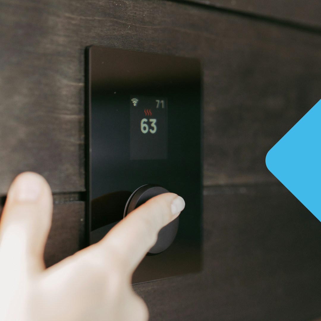person adjusting thermostat