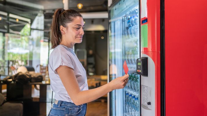 woman purchasing from vending machine