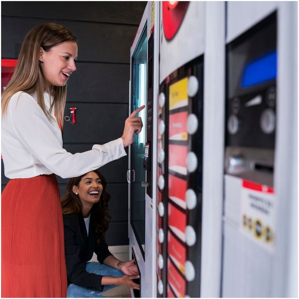 women getting food out of vending machine