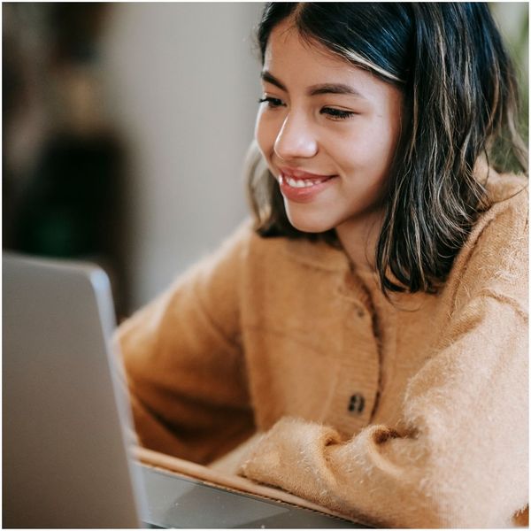 woman smiling working at her computer