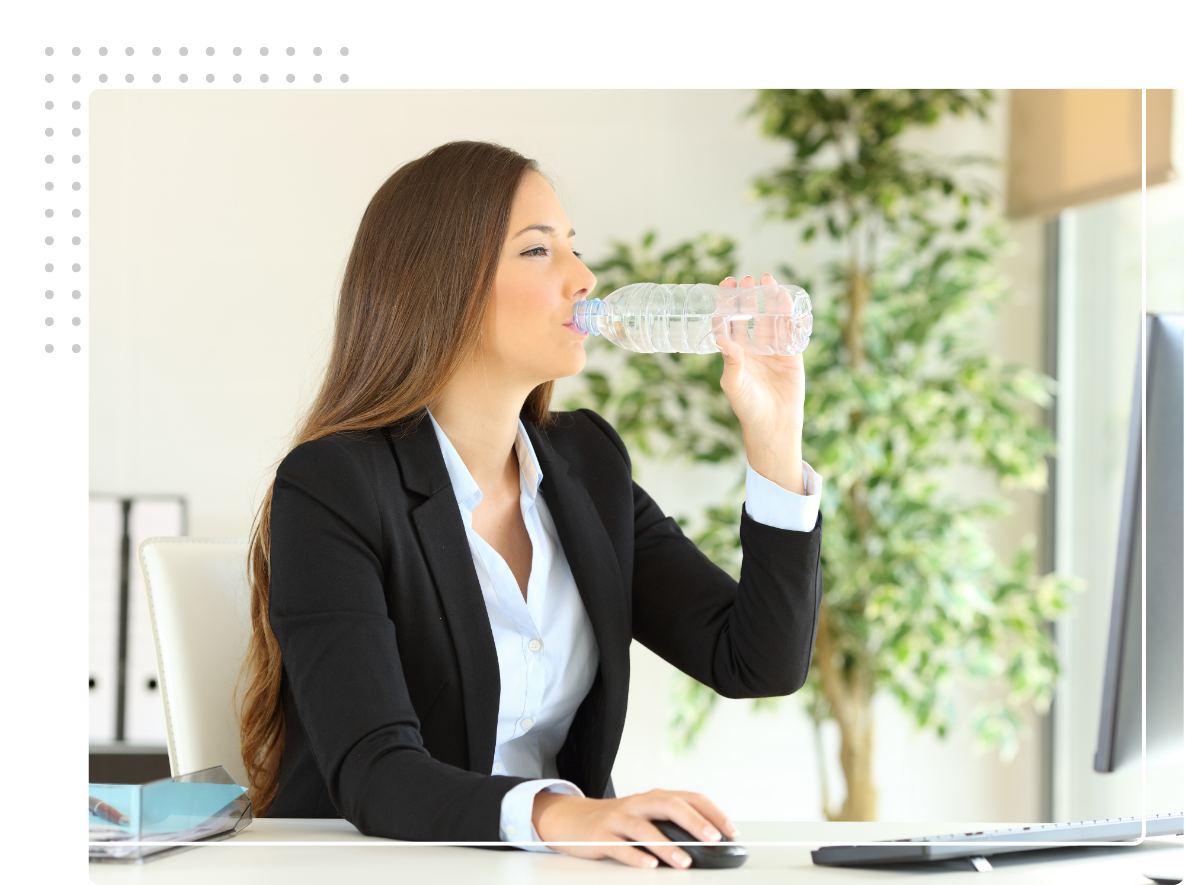 woman drinking water at work