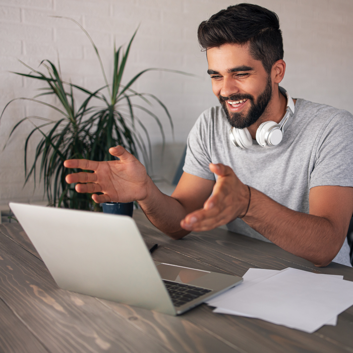 man smiling at laptop