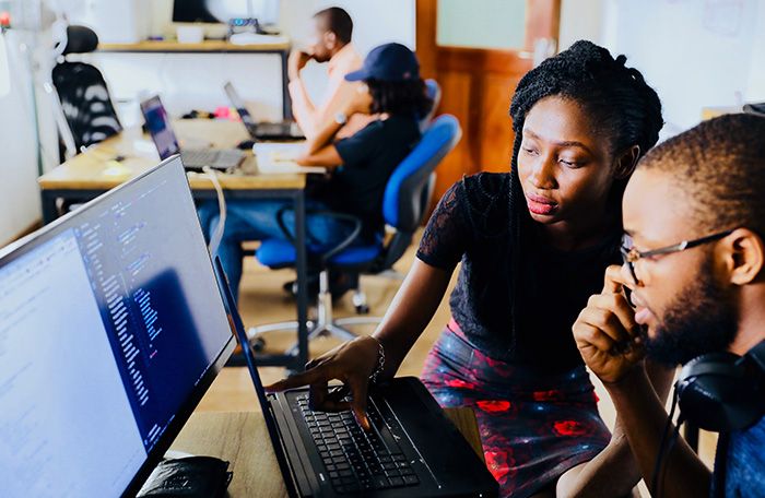 Two people working at a computer