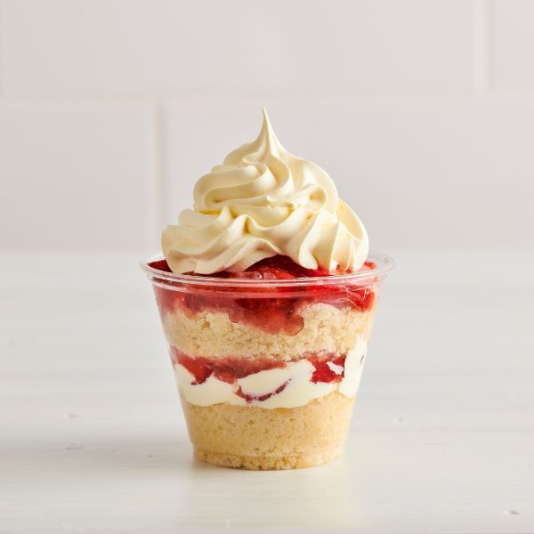 Strawberry shortcake dessert in a cup with ice cream on top