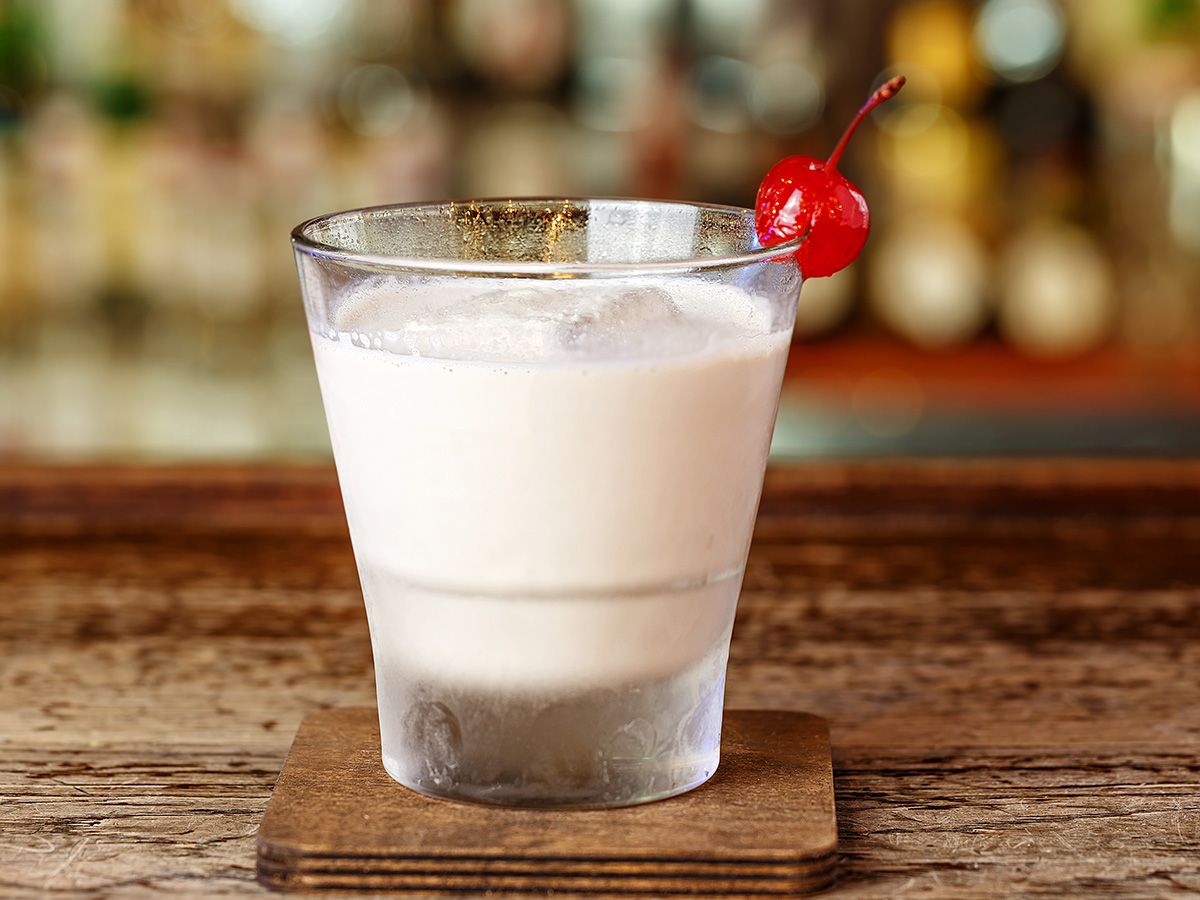 White Russian sitting on a coaster on a bar. 