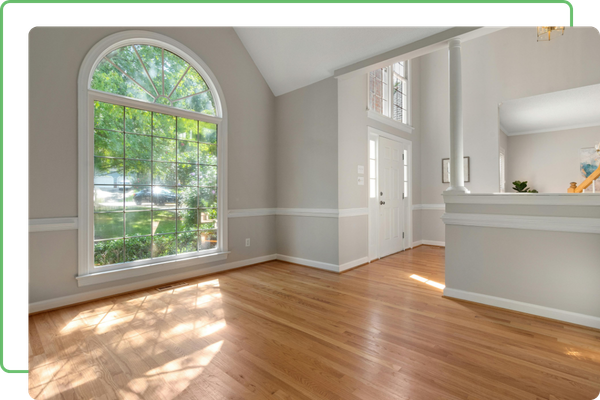 empty living space with clean floors and windows