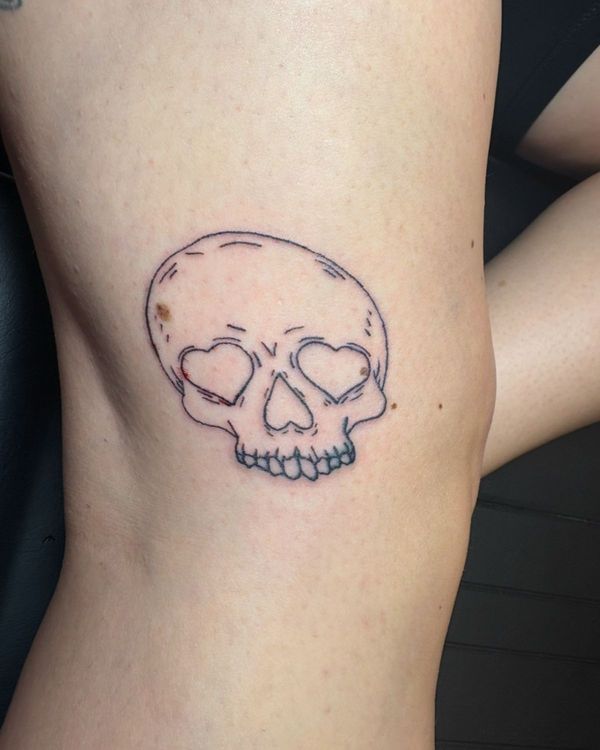 Tattoo of a skull with heart eyes