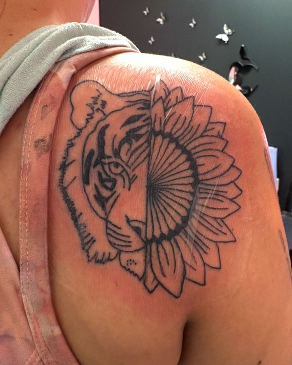 Tattoo of a half tiger and a half flower