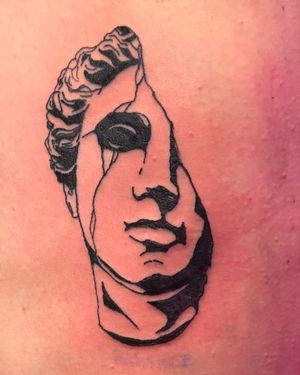 Tattoo of a statue