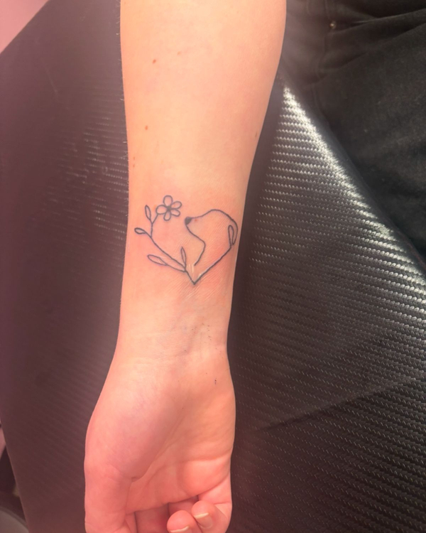 A tattoo of a dog and flower silohouette